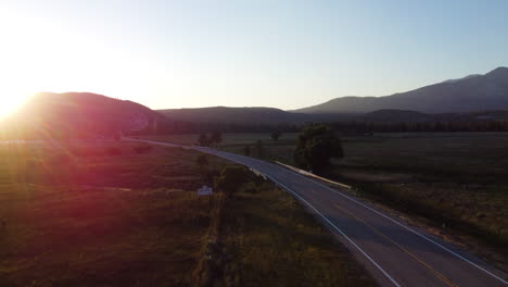 scenic highway through mountains at sunset