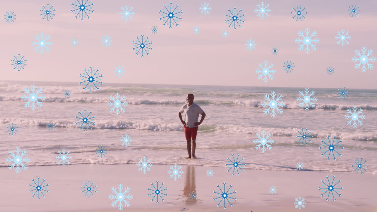 animación de copos de nieve sobre un anciano afroamericano en la playa.