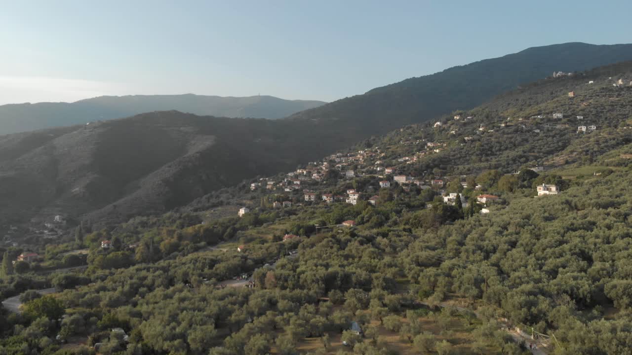 aerial drone footage of amazing landscape of green mountain with small village and beautiful blue clean sky green beautiful trees