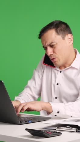 Office worker arguing on phone with green screen