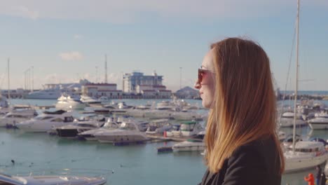 woman looking at yachts in a marina