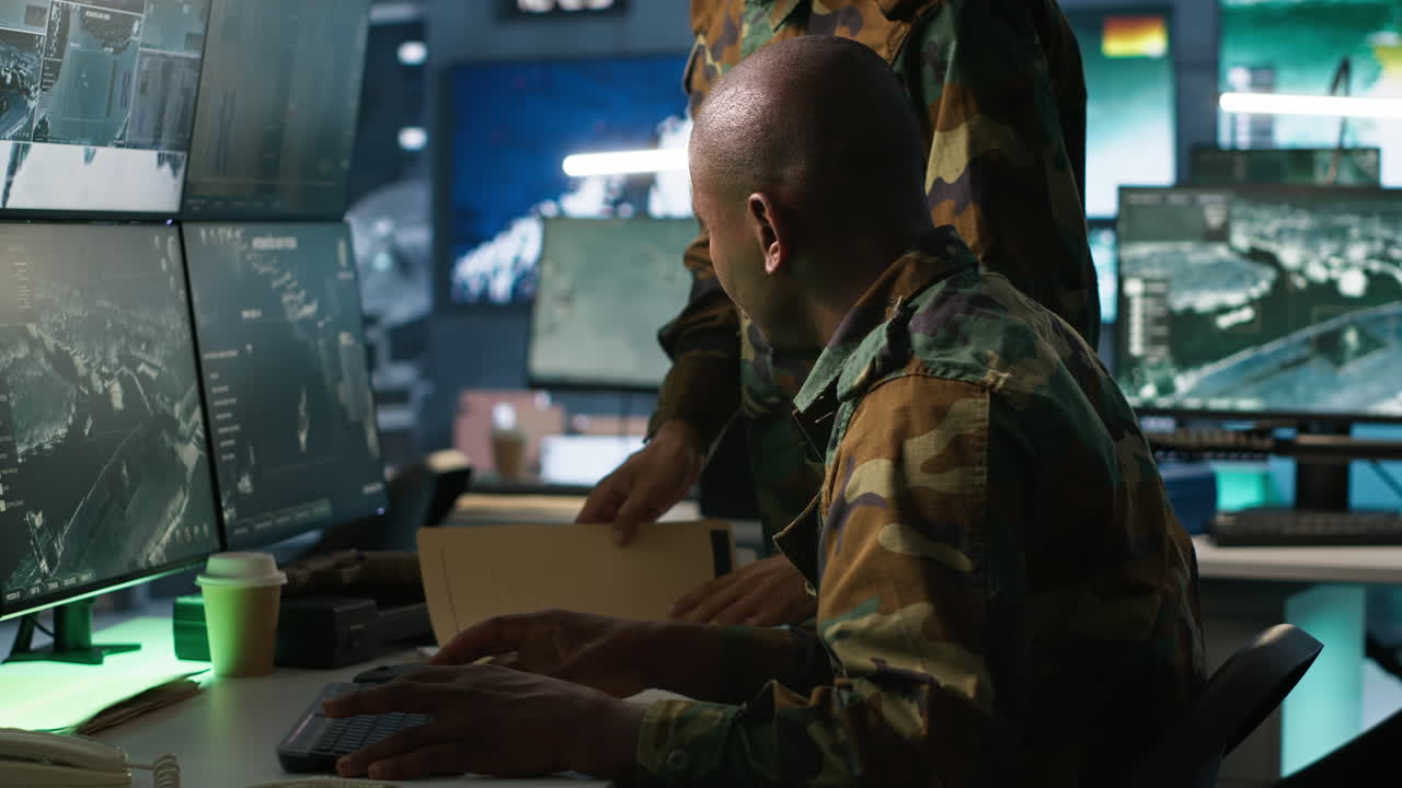 Team of military officers using tracking equipment to gain intel