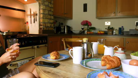 Woman-having-juice-while-using-mobile-phone-4k