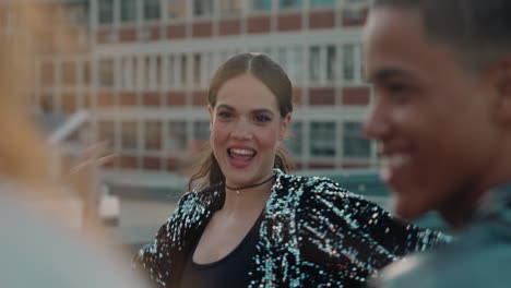 dancing woman on rooftop having fun dance party with friends at sunset enjoying crazy celebration