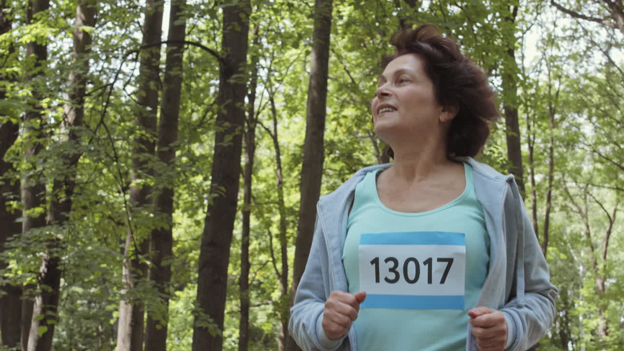 Senior Woman Running in a Forest