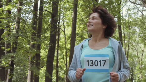 senior woman running in a forest