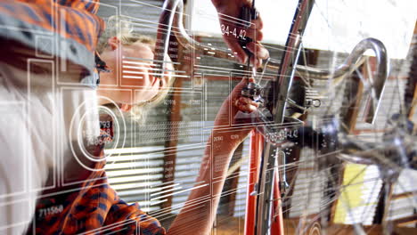 mechanic woman adjusting bicycle headset in workshop, showing floating tech hud graphs