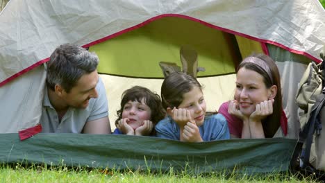 happy family on a camping trip in their tent