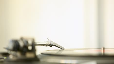 scenic close up of needle, playing head - lp player, spinning vinyl record