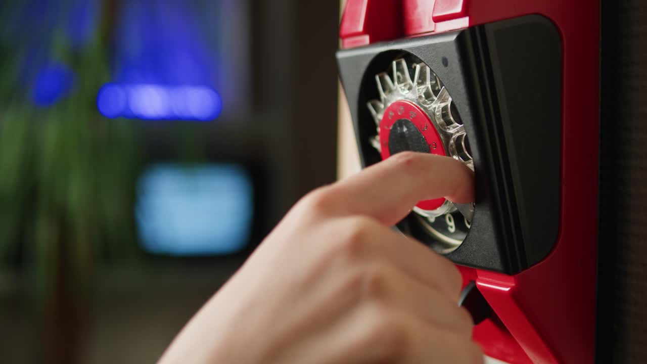 Retro vintage phone, red rotary telephone is displayed on a wooden desk, adding a nostalgic touch