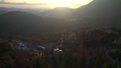 Drone-Sunset-beyond-the-mountains-of-Semmering,-Austria-Aerial