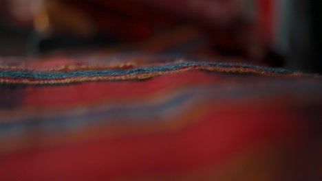 traditional handwoven guatemalan textiles made and sold by local mayans at markets in antigua, guatemala - rack focus