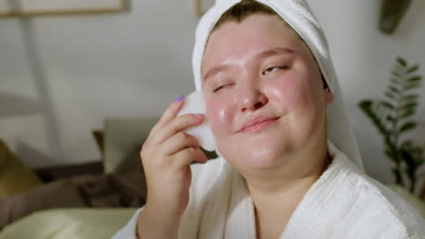 young woman massaging her face