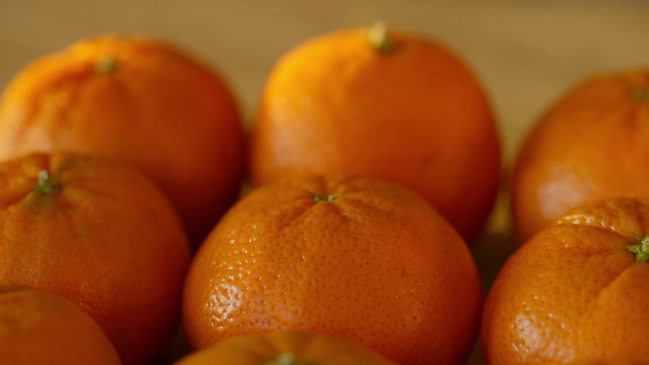 slow slider view of yummy sweet mandarin oranges laying on a table