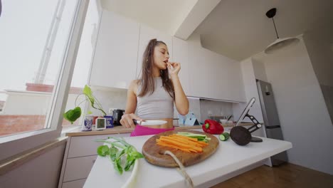 young woman prepares and snaps on healthy vegetables in kitchen