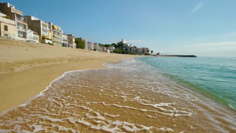 Platja-de-les-Barques-sea-field-Maresme-Barcelona-Mediterranean-coast-plane-close-to-turquoise-blue-transparent-water-beach-without-people