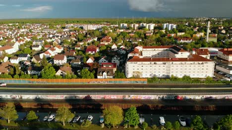 aerial view overlooking the townscape of the raunheim town, sunny, summer evening, in germany - tracking, drone shot