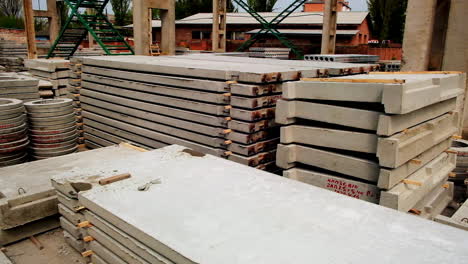 Various construction materials produced from armored concrete. Cement items for building placed outside in the plant zone.