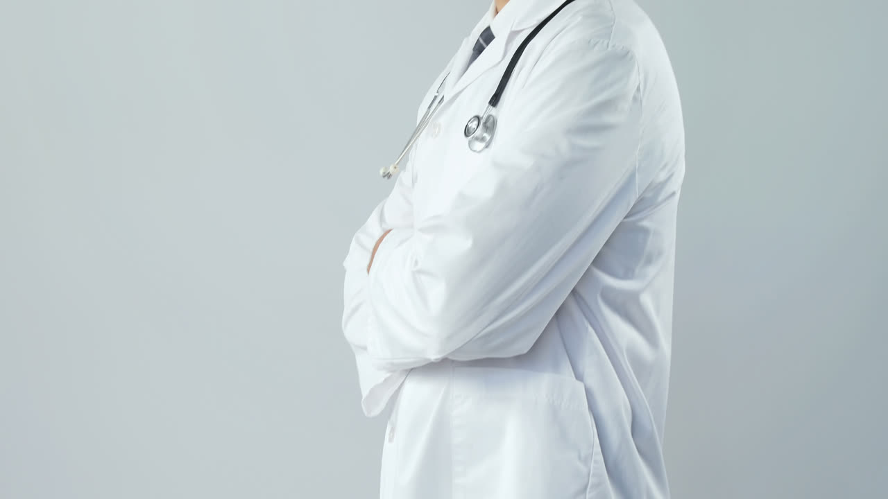 Smiling doctor standing with his hands crossed 4K 4k
