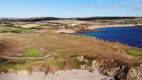 aerial pan of thurlestone golf course and cliffs