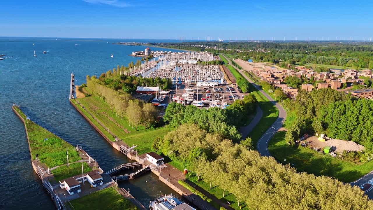 View on the yacht club of Lelystad, the Netherlands. Beautiful green lakefront of the town at the Merkemeer Lake. Aerial perspective.