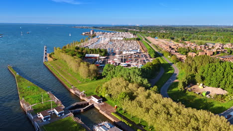 view on the yacht club of lelystad, the netherlands. beautiful green lakefront of the town at the merkemeer lake. aerial perspective.