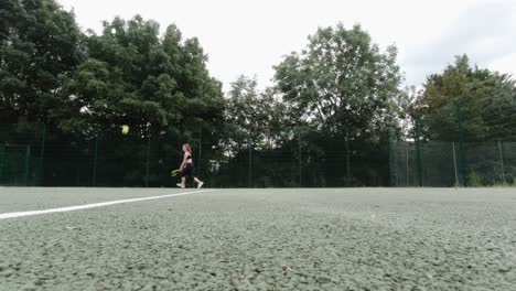 caucasian female  in black outfit playing tennis