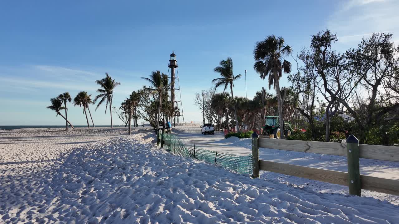 Walking around and on the white sands at Sanibel beach Florida with lighthouse in the background