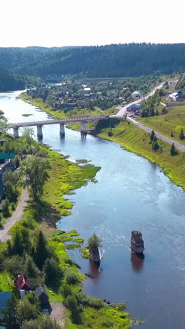 aerial view of a river, bridge, and village