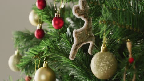 closeup of christmas balls and decorations on the green christmas tree