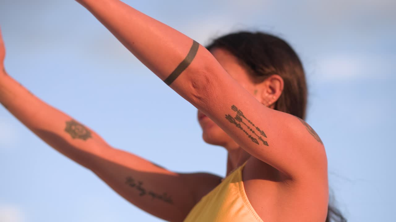 Woman performing yoga asana poses at sunrise