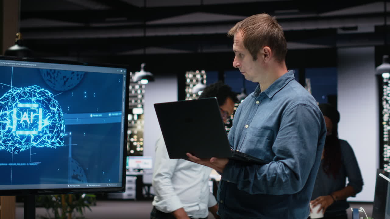 Man Working on Laptop in Modern Office with AI Display