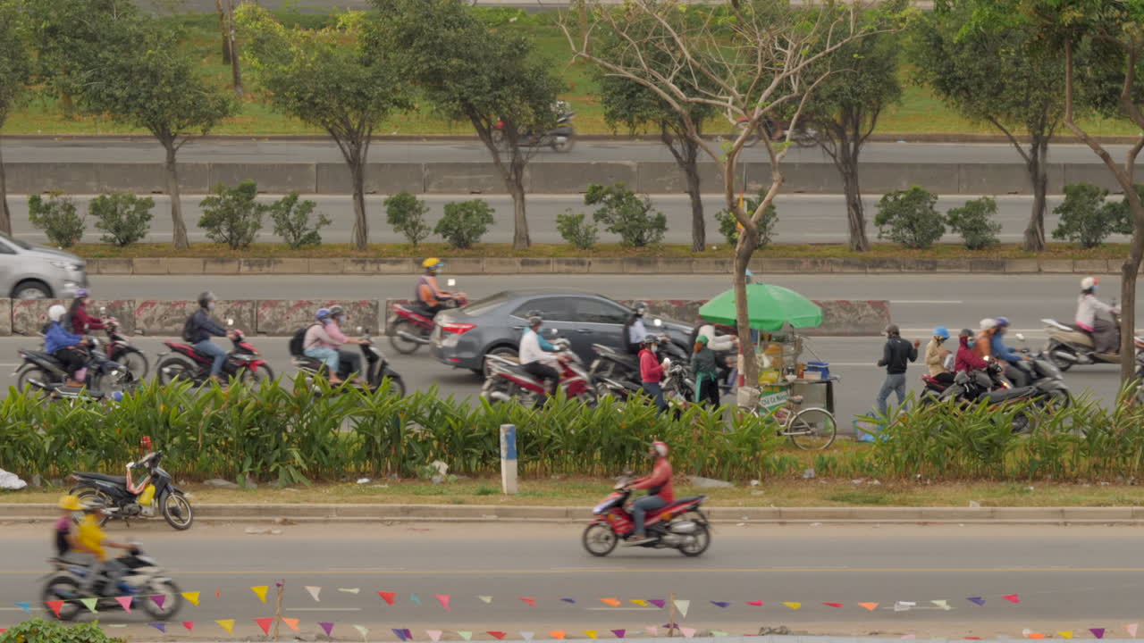 Slow motion shot of layered busy traffic on Vietnamese highway