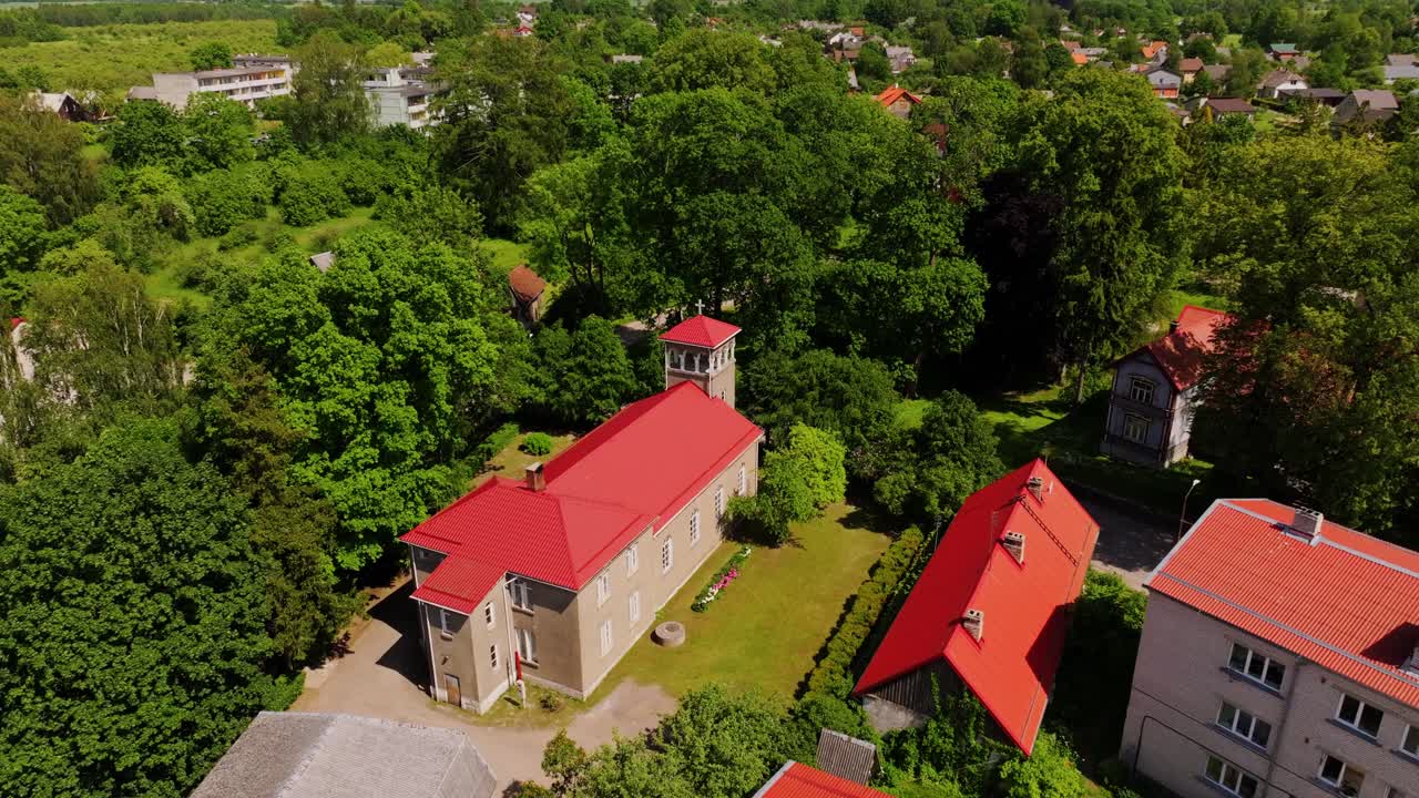 Drone Flight Over Aizpute Baptist Church, Bright Roof Amid Historic Small Town