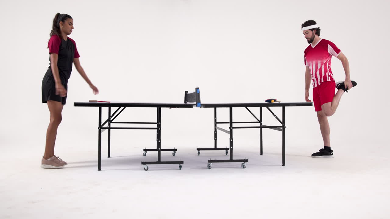 Playing table tennis, man and woman facing each other in intense match