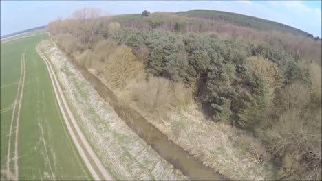 a drone flying around just one of the thousands of forests of the united kingdom