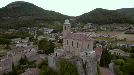 The-chapel-Notre-Dame-de-la-Consolation,-built-in-1894-atop-a-rocky-spur-overlooking-a-village-in-Pierrelongue