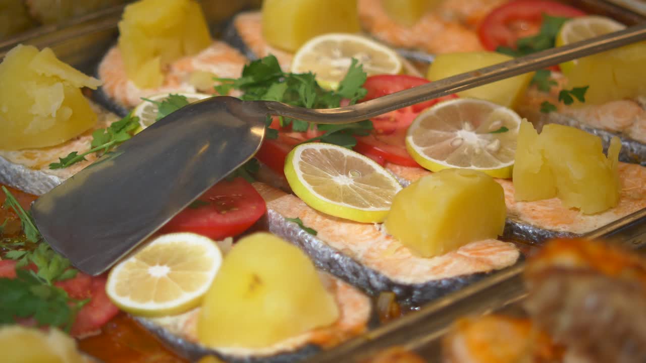 Salmon dish with lemon, tomatoes, and potatoes
