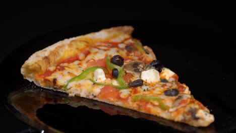 piece slice of pizza with vegetables and cheese. olives, pepper and tomato