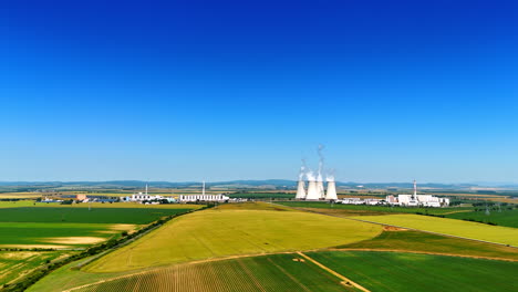 industrial plant in the countryside of slovakia. vast agricultural fields from aerial view.
