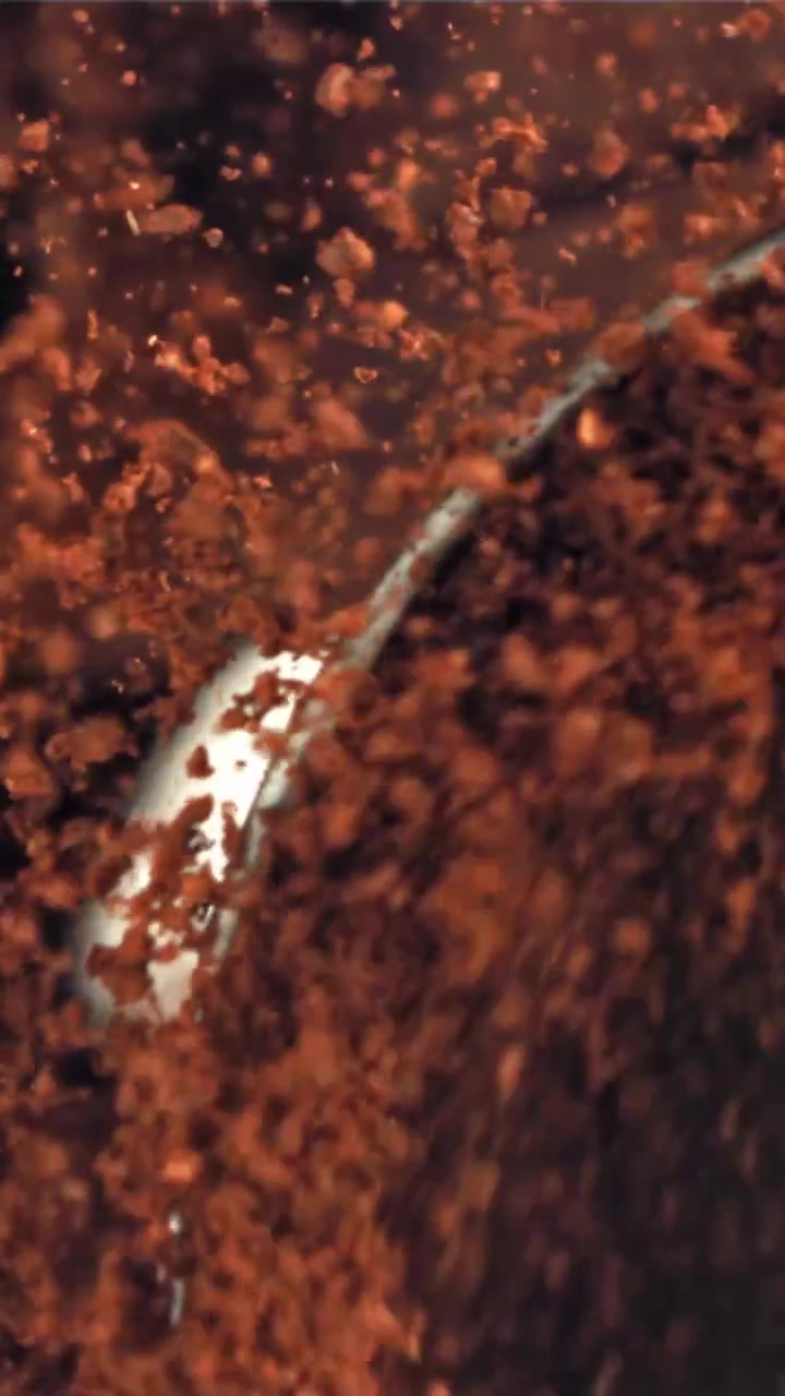 Macro Close-up of Coffee Grounds Mixing and Swirling