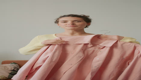 girl presenting clothing and sharing outfit ideas during fashion vlog recording