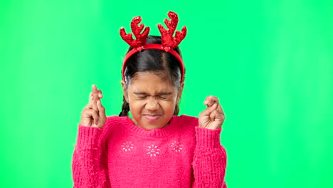 child, christmas and wish on green screen fingers