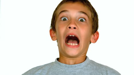 boy grimacing against white background