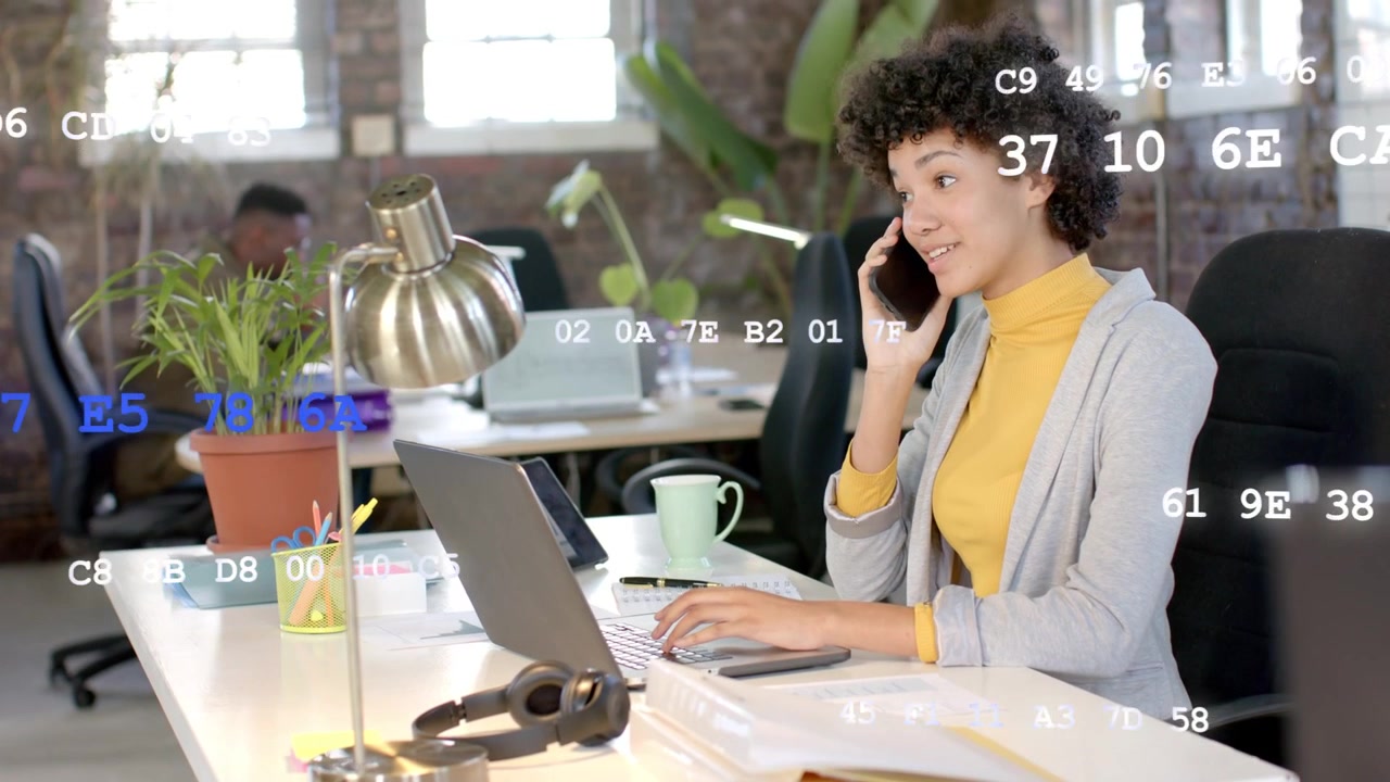 Woman receiving call, typing on laptop, checking screen, code overlays appearing, coordinating tech