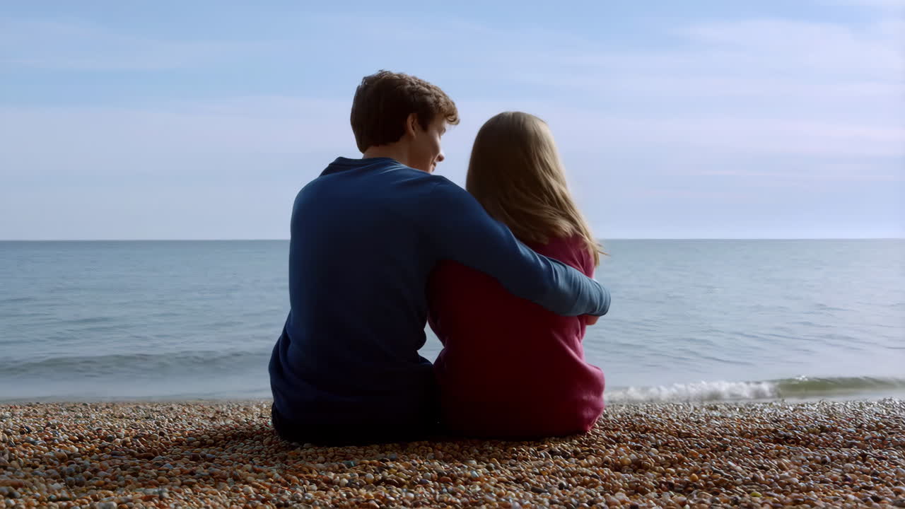 Couple embracing on a pebble beach