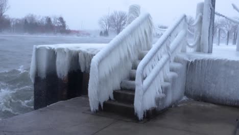 wide static shot of a frozen staircase during a winter storm