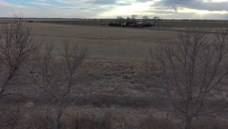 an aerial dolly pan over trees on a dry farm near sterling colorado 2021