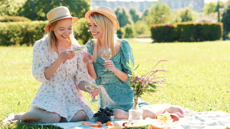 two women enjoying a picnic in a park