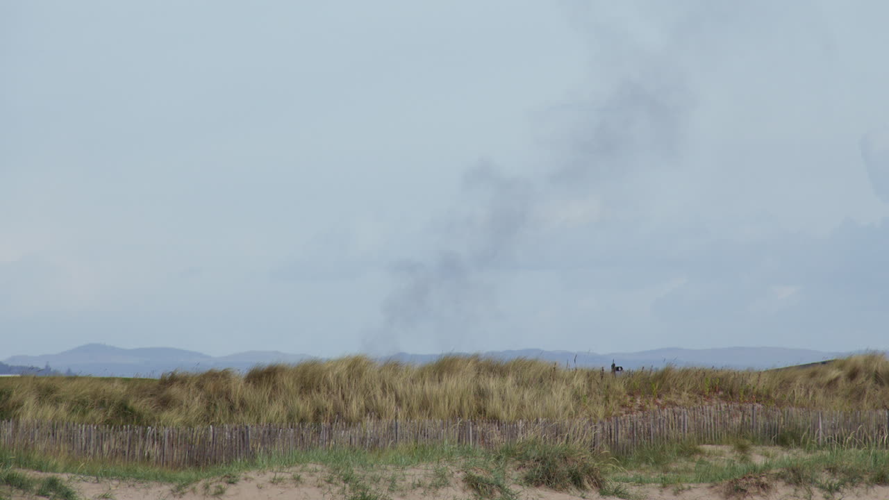 Distant smoke from a fire over the new course at Saint Andrews